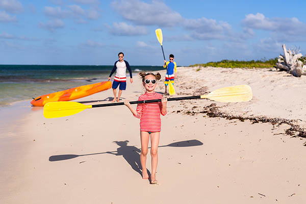 Family kayaking on a tropical beach