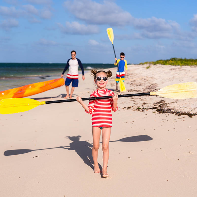 Family kayaking on a tropical beach