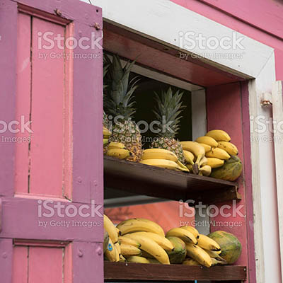 African male chef sprinkling spices on dish in commercial kitchen in the Caribbean