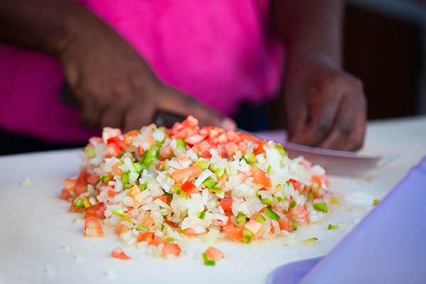 Bahamian woman making traditional conch salad