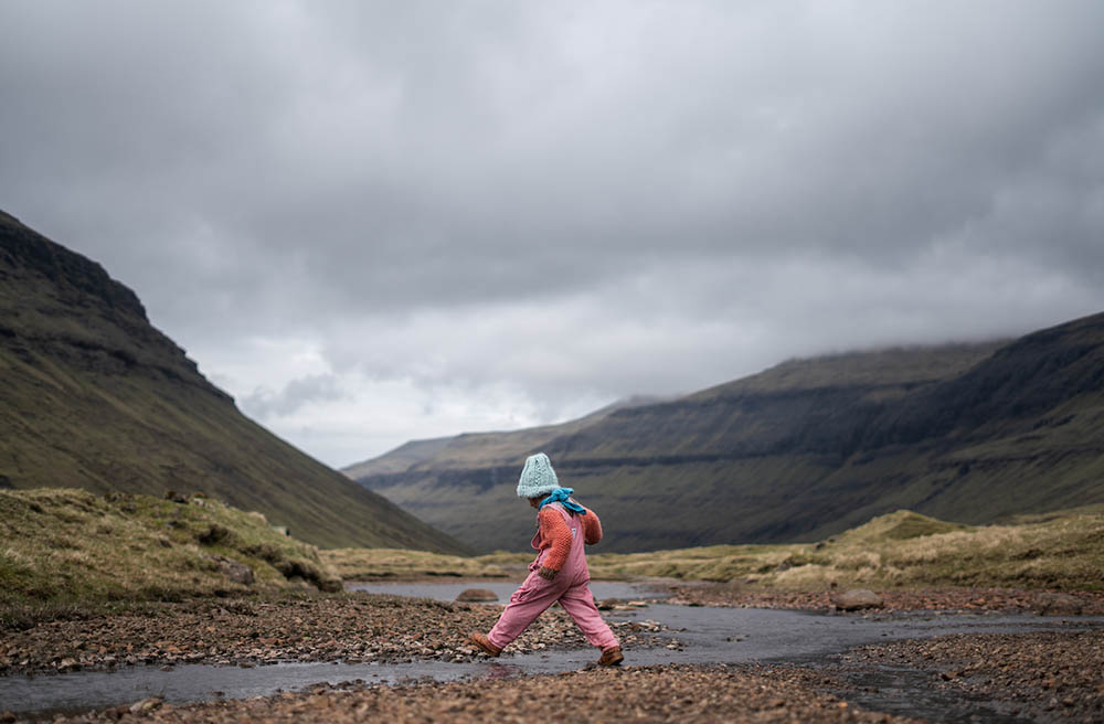 child out in nature in the faroe islands, denmark