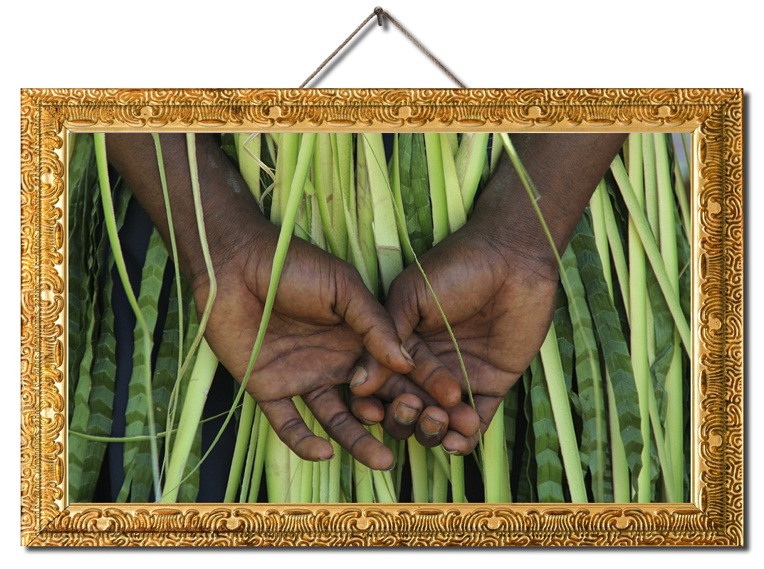 Close-up of boy's hands in a traditional grass skirt