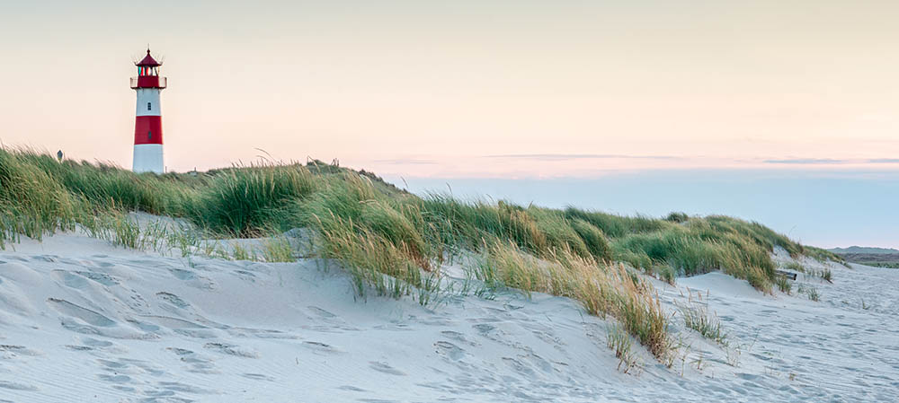 Panoramic view of a lighthouse standing on a beach