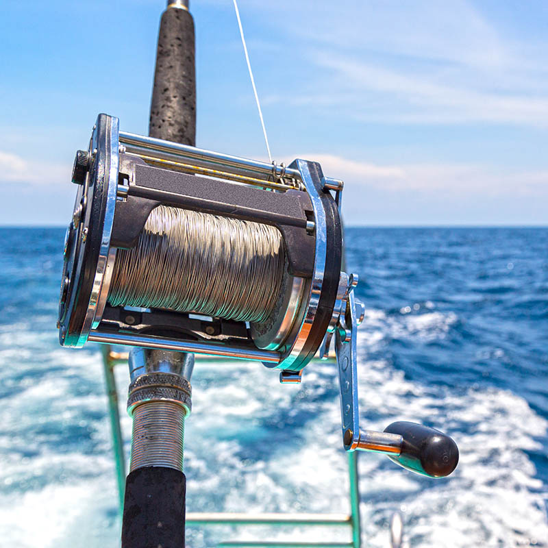 Ocean fishing boat aboard against a blue clear sea water