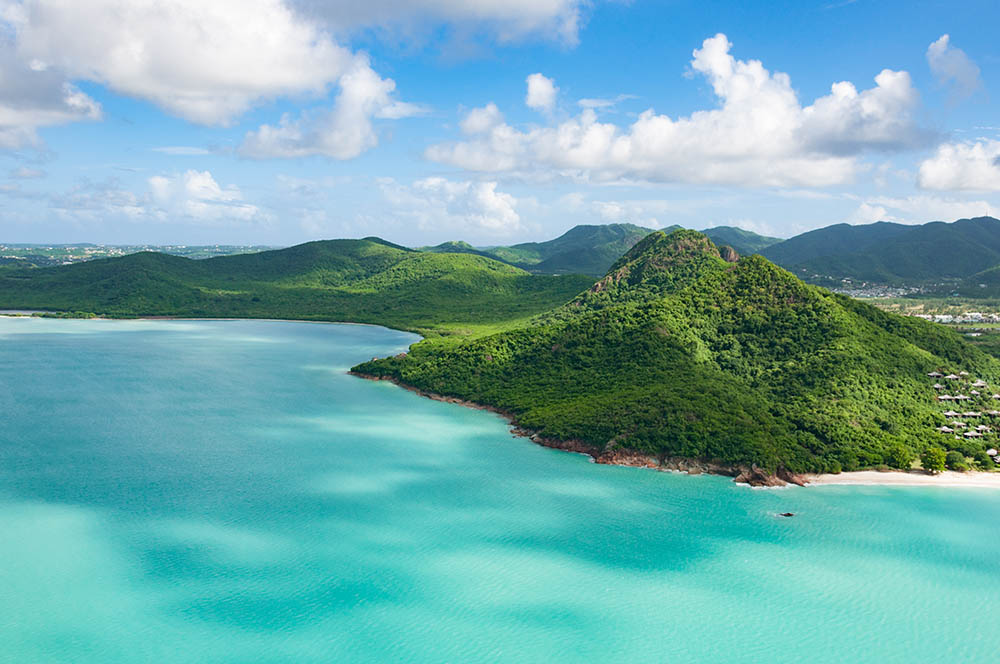 Helicopter view to the Caribbean island Antigua with mountains and rainforest