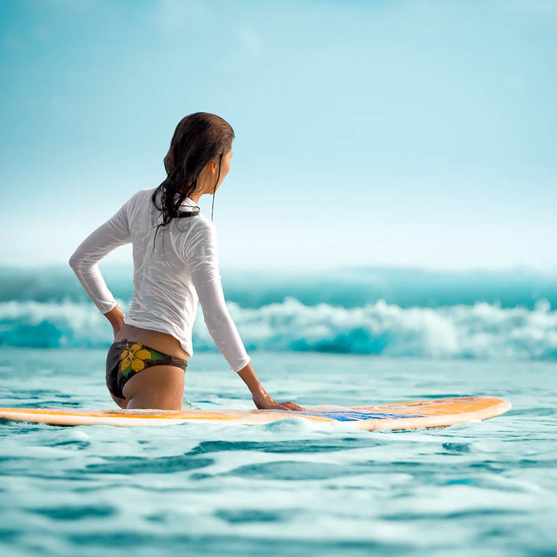 Surfer girl in the ocean