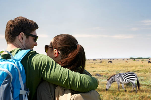 happy couple with backpacks traveling