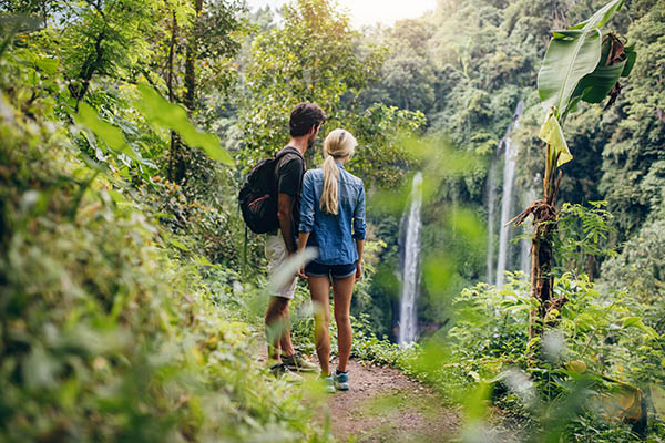 Romantic couple on honeymoon looking at a waterfall in Colombia