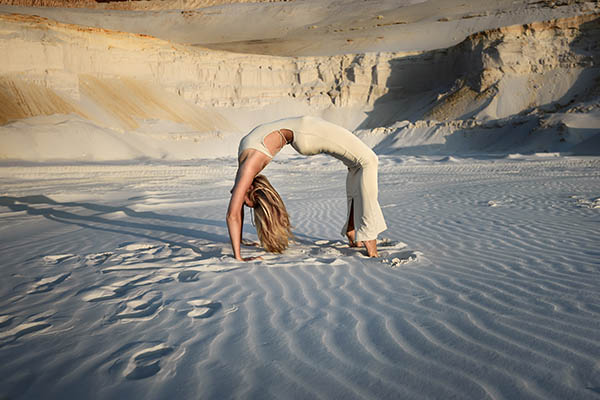 Woman practising yoga in the desert