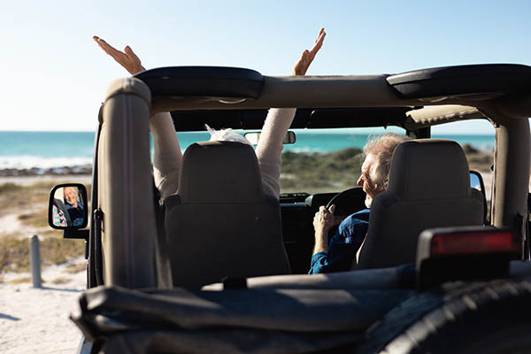 Romantic older couple in a car at the beach