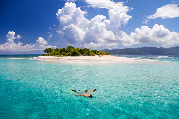 Just married couple running on a caribbean beach