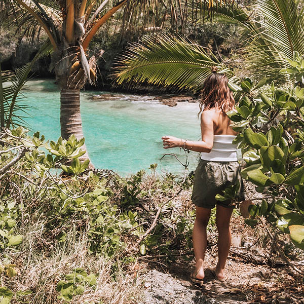 Woman hiking near Wabao Bay, Maré island New Caledonia