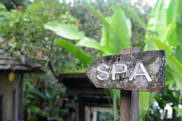 wooden spa sign in tropical surroundings