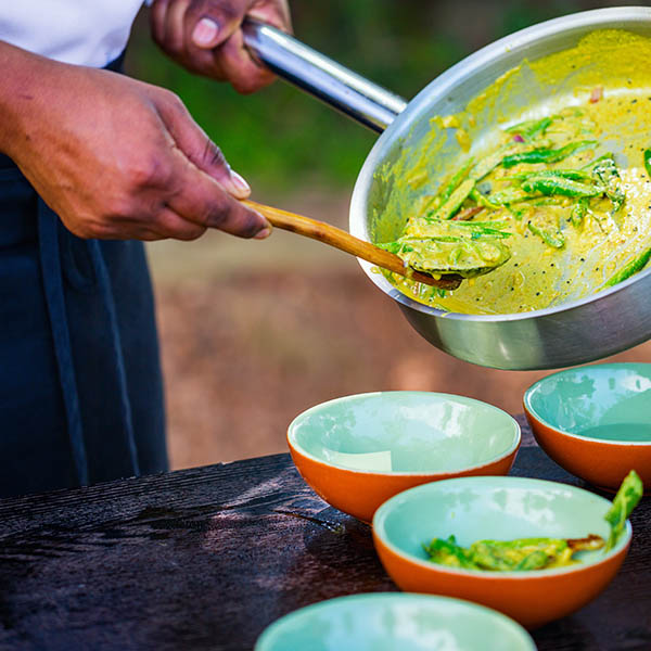 Chef making traditional Sri Lankan curry dish at cooking class