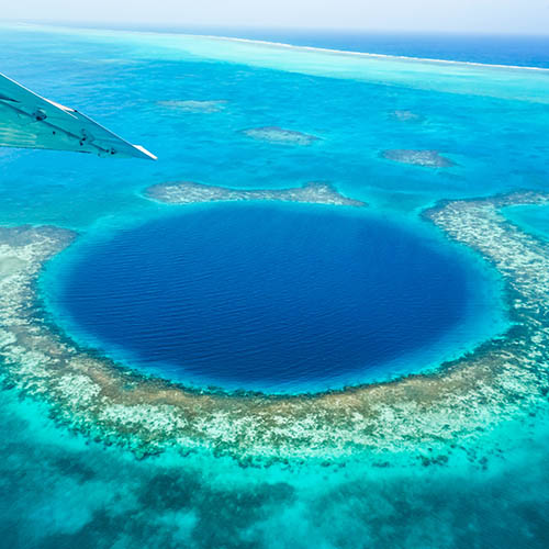 Flying over the Blue Hole in Belize in a light aircraft