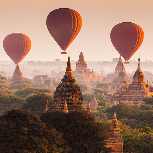 Hot air balloon over plain of Bagan in misty morning, Myanmar