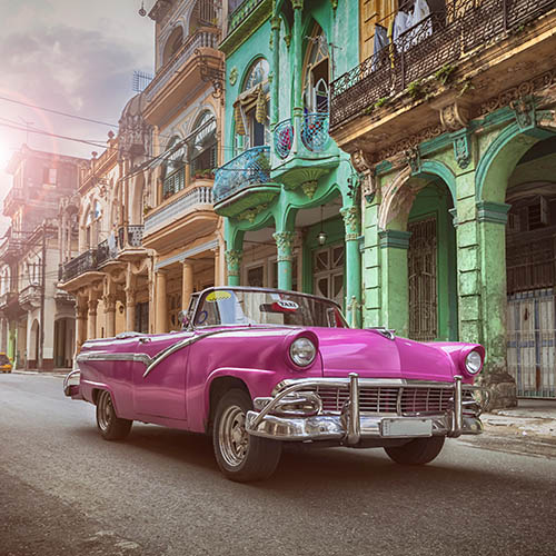 Vintage classic pink American convertible car in old town of Havana Cuba