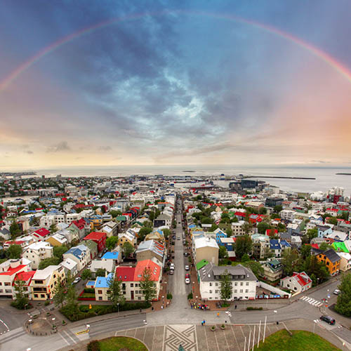 Aerial view of Reykjavík with a rainbow