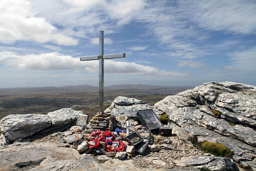 Memorial cross and memorabilia on top of Mount Tumbledown, site of a battle that took place during the British advance towards Stanley in the Falklands in 1982