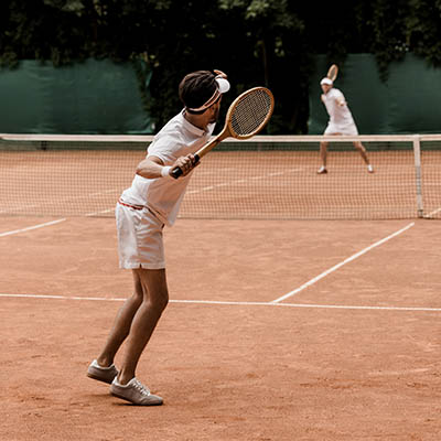 Retro styled tennis players playing at tennis court