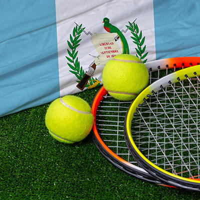 A tennis racquet with tennis ball on Guatemala flag