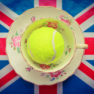 British Tennis - A cup and saucer with a tennis ball inside on top of a union jack flag