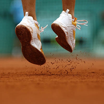 Close up of a woman's feet wearing trainers playing tennis