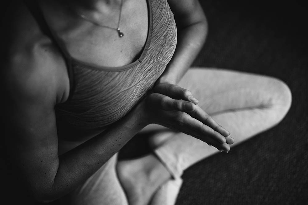 Black & white image of a woman in yoga pose