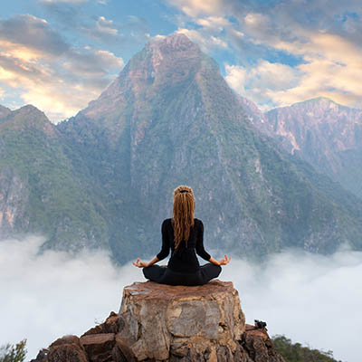 Girl sitting in yoga pose at the Nong Khiaw viewpoint in Northern Laos