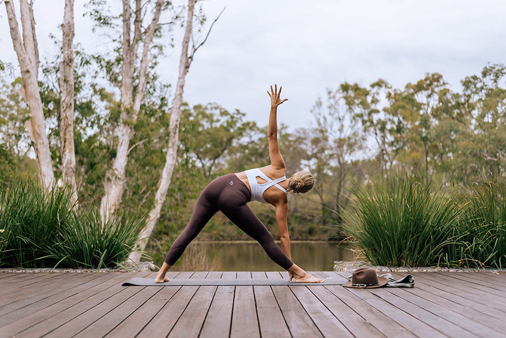 Young woman practicing yoga pose at Mount Mulligan Lodge, Queensland, Australia