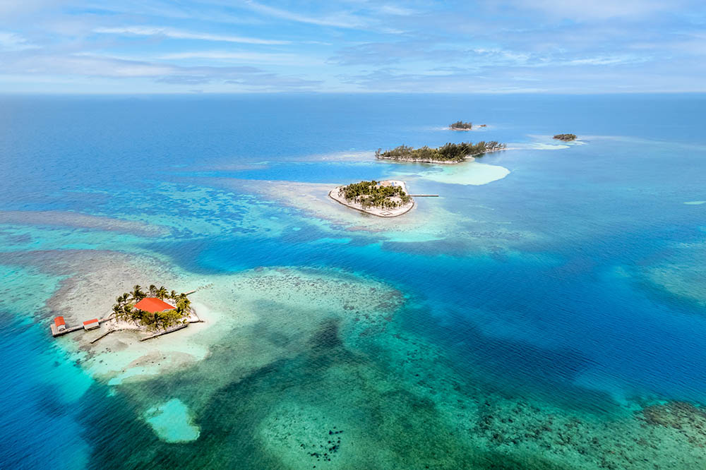 Remote tropical islands surrounded by turquoise water and vibrant reef, Utila Cays Honduras