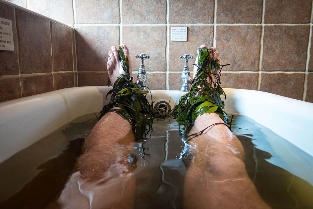 Close up of a man's feet during a Seaweed Bath in Ireland