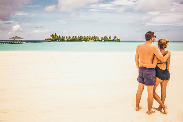 Honeymoon couple standing on a beach in the Maldives