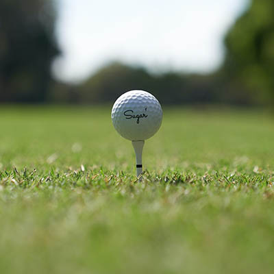 White golf ball on green grass during daytime